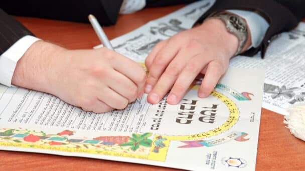 Traditional jewish wedding, signing ketubah. Jewish marriage contract or covenant
